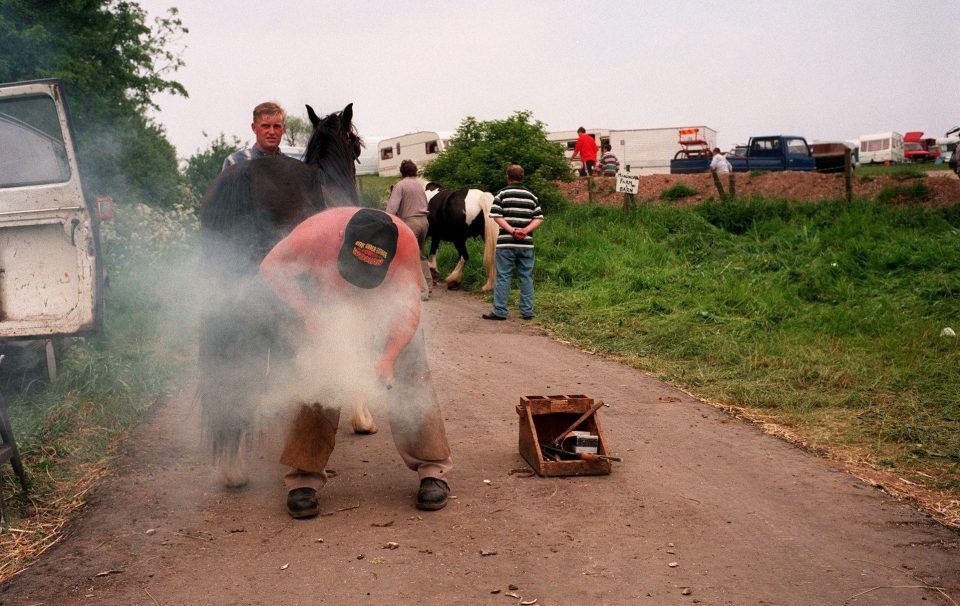  A farrier goes to work before the cut throat business of horse trading begins at Appleby Horse Fair in the 1990s