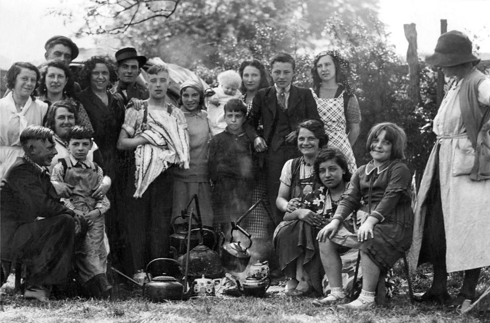  Travellers gather with their family around a camp fire at Appleby Horse Fair in June 1934