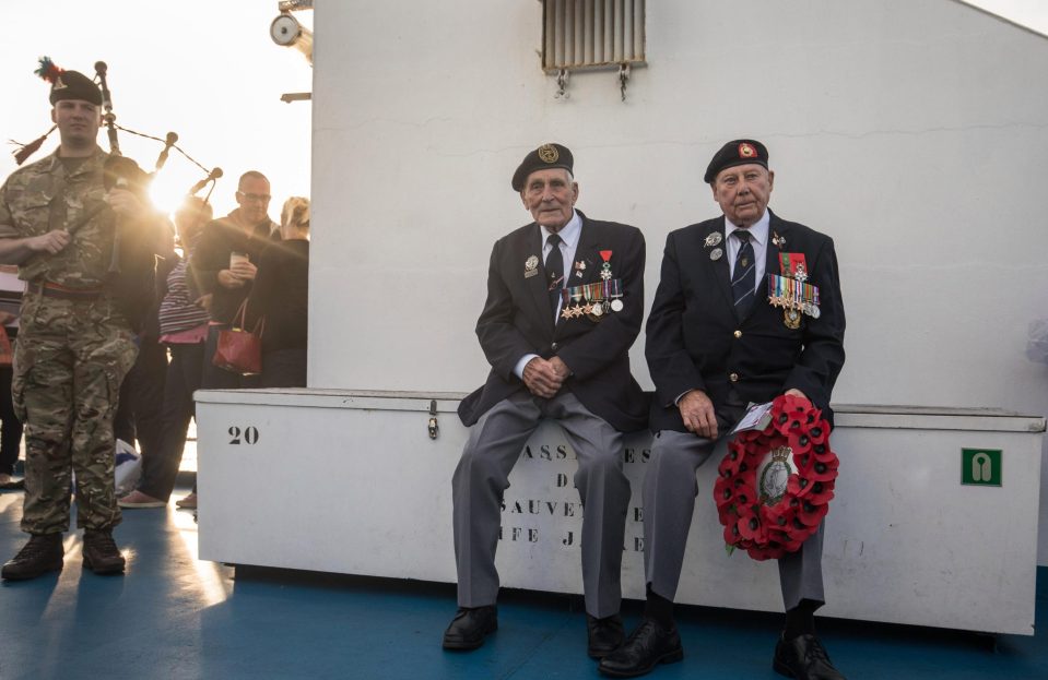  Normandy heroes sit during the at-sea wreath laying