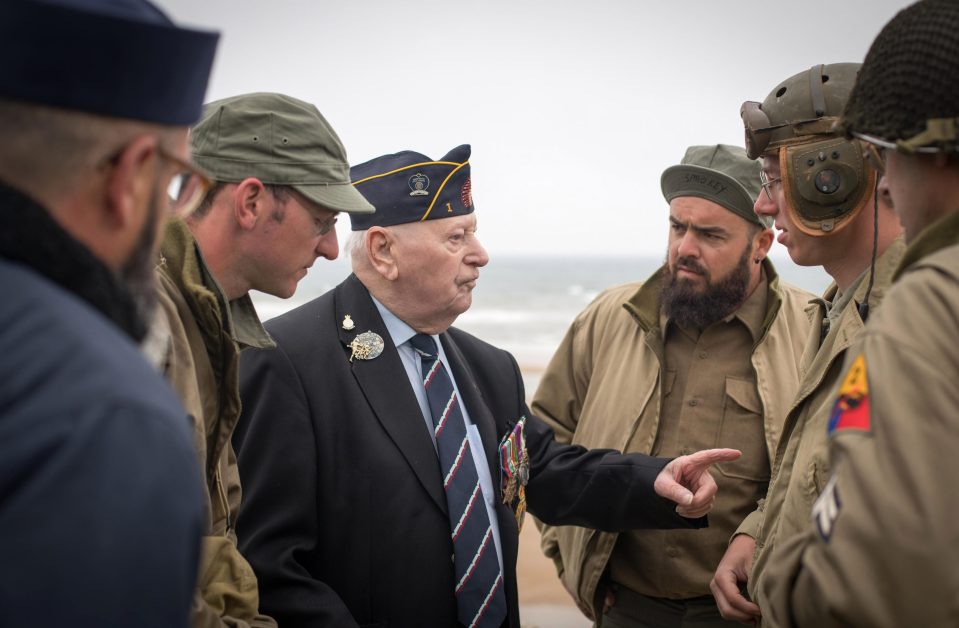  World War 2 re-enactors talk with Normandy veterans attending a wreath laying ceremony at the Tactical Air Force Memorial