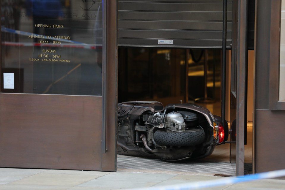 A raider’s motorbike is left in the doorway of Watches of Switzerland