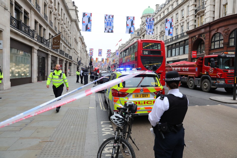 Police stand on guard at the scene of the robbery in Regent Street today