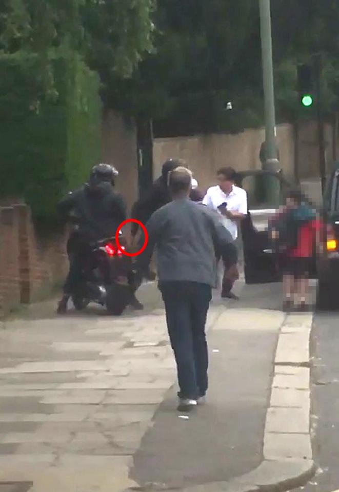  A knife was seen poking from robber's sleeve during the raid in North London