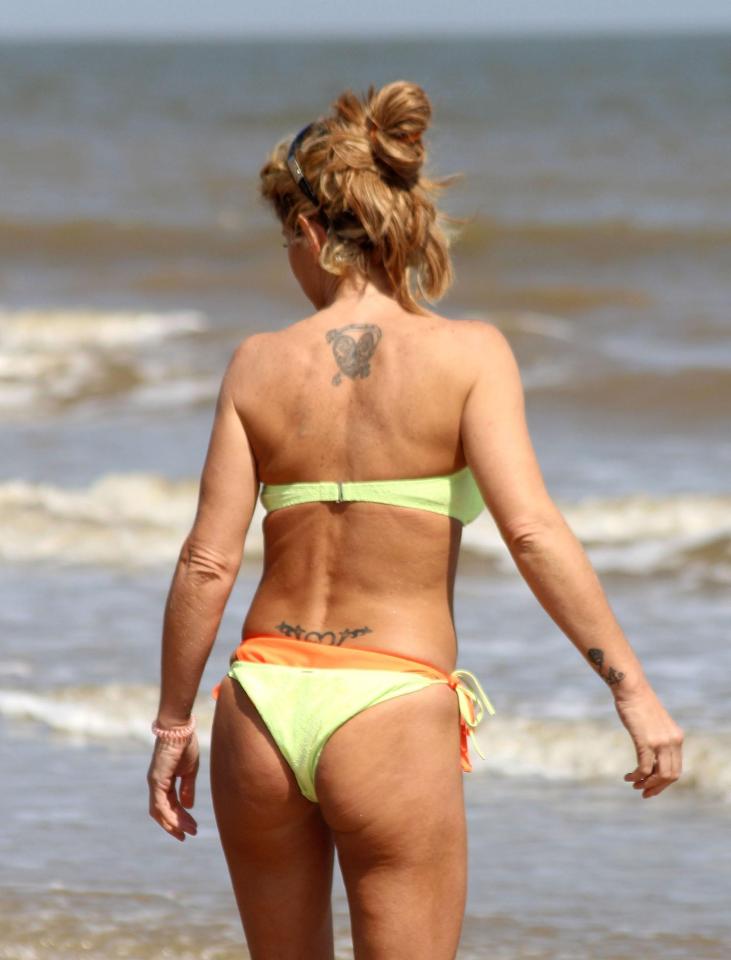  The star rocked a bright yellow bikini as she frolicked on the beach in Frinton-on-Sea