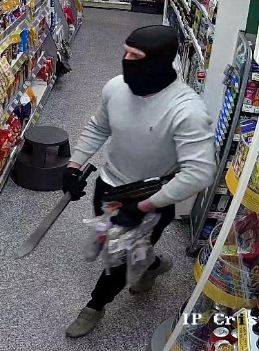  Two masked thugs armed with machetes threatened staff during a terrifying raid on a One Stop shop in Bury