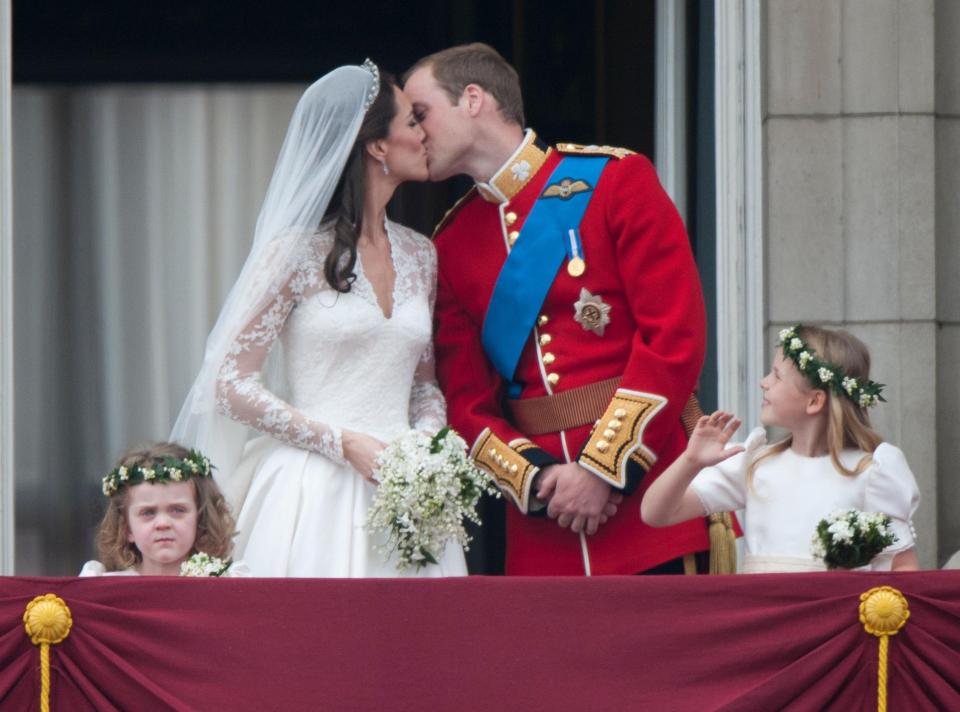  Prince William shares a kiss with Kate Middleton on the balcony at Buckingham Palace