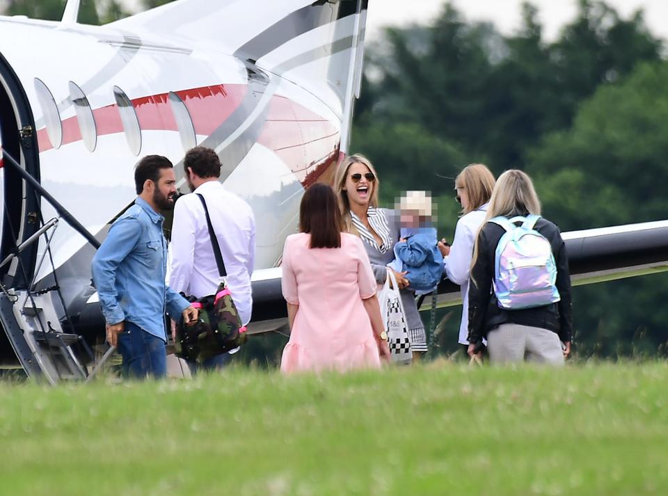  The couple looked happy and relaxed as they chatted with friends and family ahead of their flight