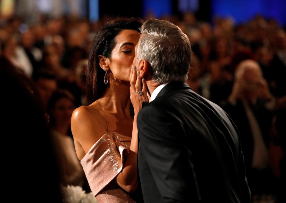  Amal and George Clooney kiss as he is honoured at a Hollywood gala