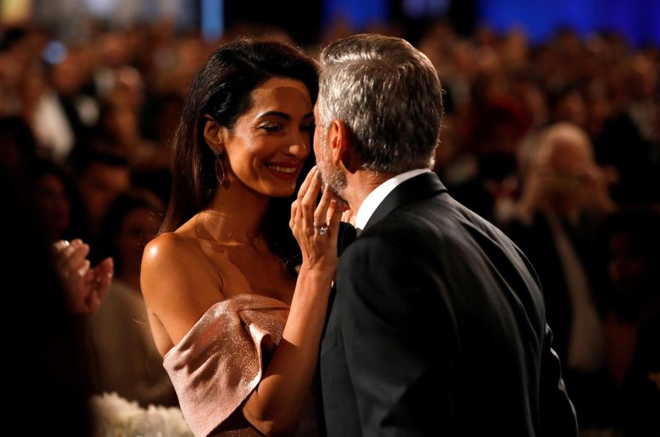  By George! Amal looks proudly as her husband is honoured by a galaxy of movie stars