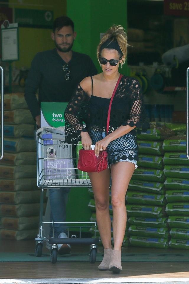  Caroline looked chic in denim shorts and a black crochet cover up