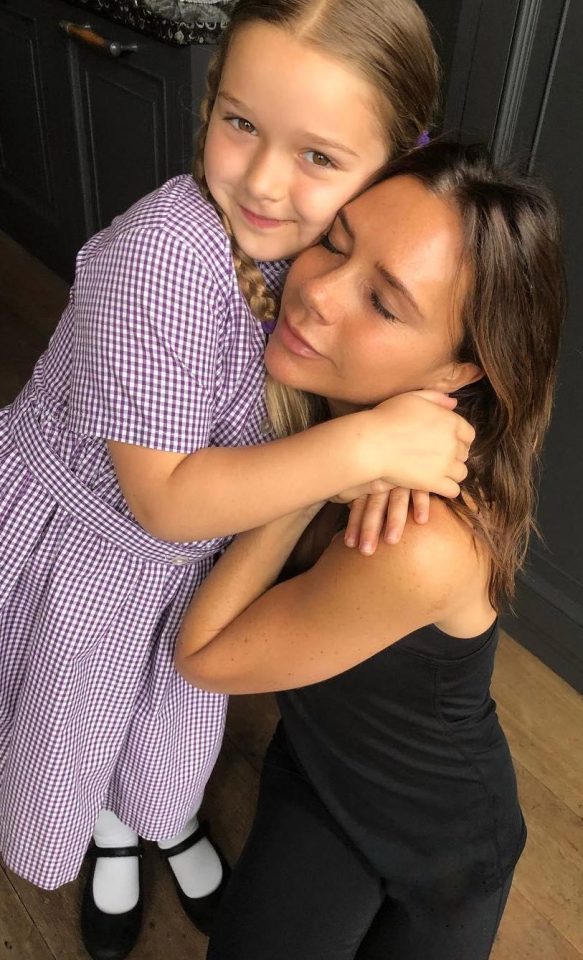  Mum's the word ... Victoria enjoys a hug from daughter Harper, writing on Friday that they 'loved and missed' husband David