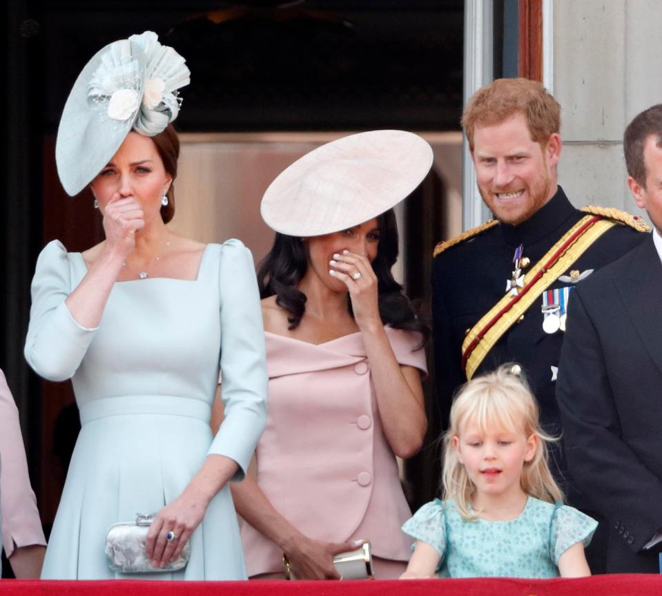  Meghan covers her mouth as she chats to Harry on the balcony of Buckingham Palace