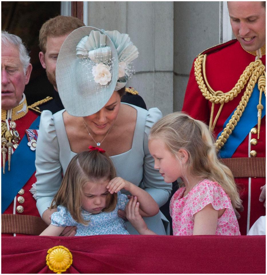  The Duchess of Cambridge tends to Princess Charlotte on the Buckingham Palace balcony