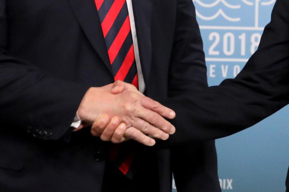  Macron grips Trumps hand tightly as he gains the upper hand