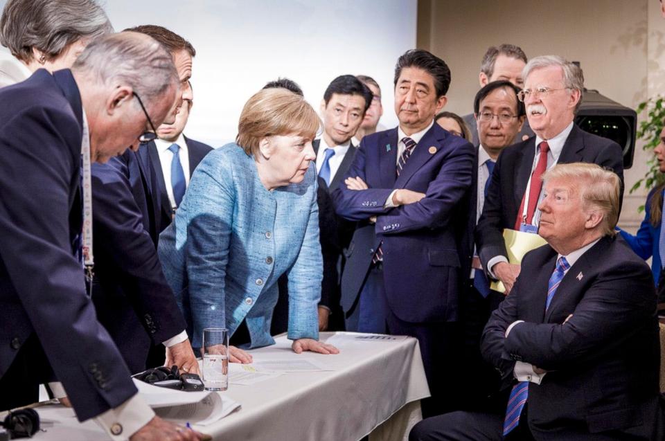  An extraordinary photo of Angela Merkel, Donald Trump and other world leaders at the G7 summit has sparked dozens of memes