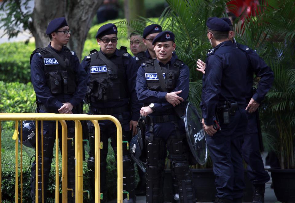  Armed cops stand outside the St Regis hotel where Kim is a guest