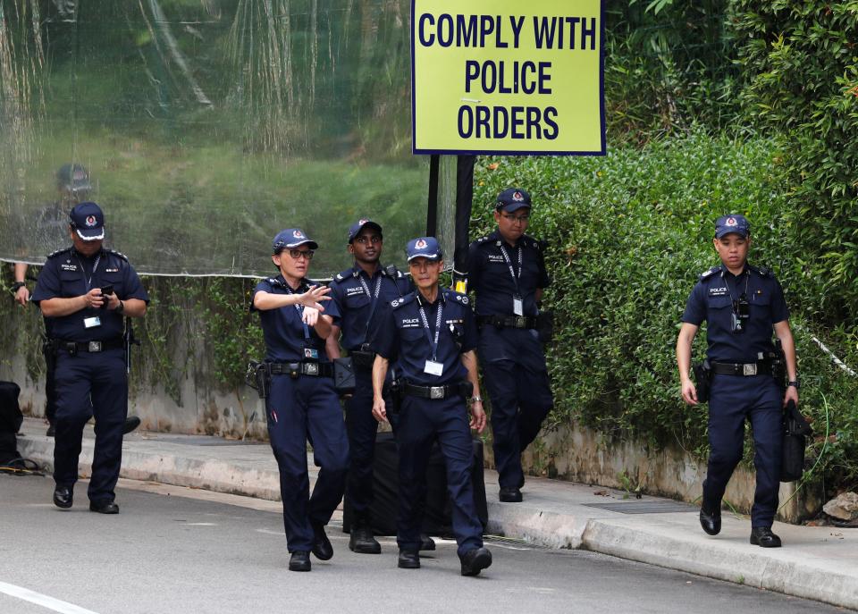  Police officers are seen at the Capella Hotel, the venue for the June 12 summit