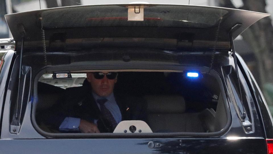  They've got his back covered... a secret service sniper can be seen holed up in the boot of a motorcade limo