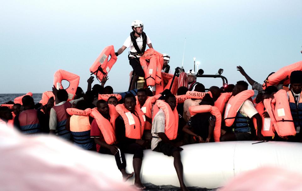  Aquarius staff hand out life jackets as they rescue more migrants on June 9