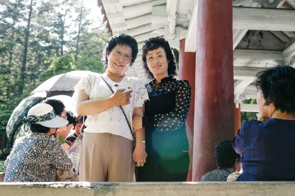  Two women smile for the camera in North Korea