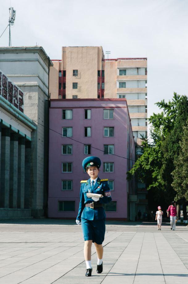  A female soldiers walks through the city in Pyongyang