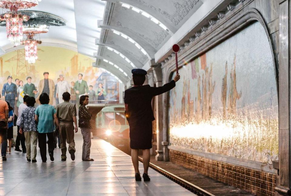  A female train conductor at a North Korean station