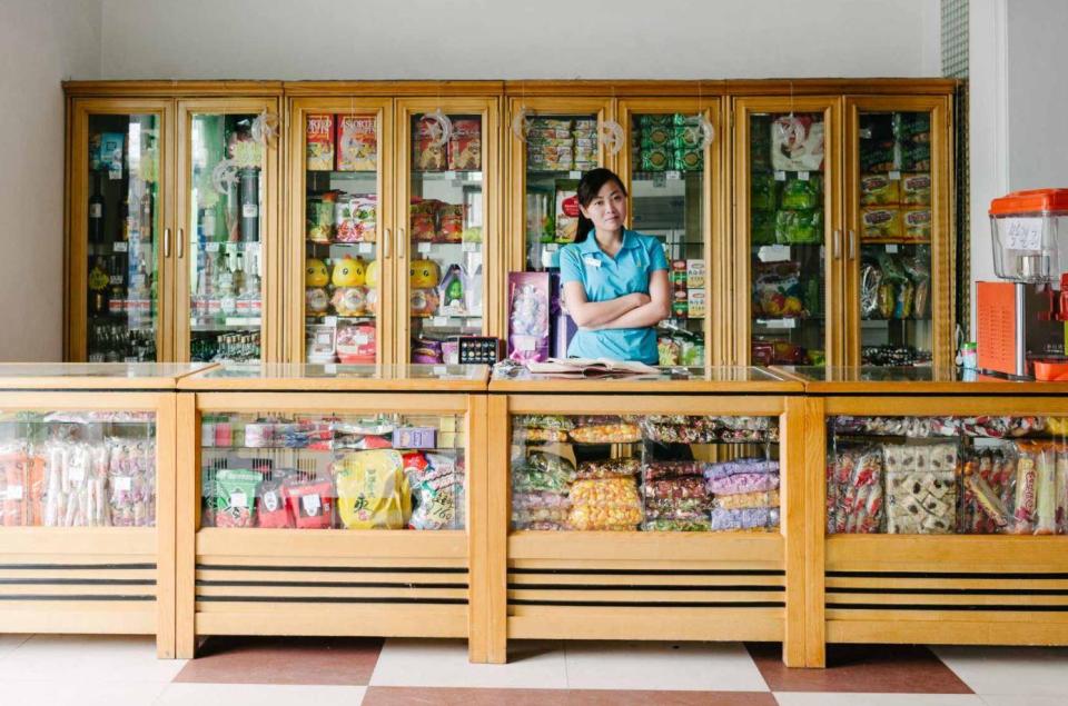  An assistant in a colourful food shop in Pyongyang