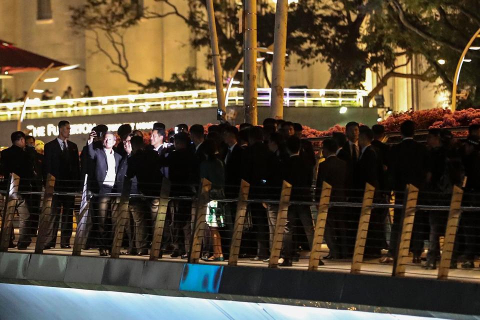  The ever vigilant bodyguards surround Kim as he takes a selfie with Singapore's Foreign Minister Vivian Balakrishnan and Education Minister Ong Ye Kung