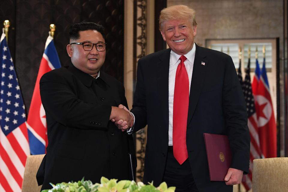  US President Donald Trump and North Korea's leader Kim Jong Un shake hands following a signing ceremony during their historic US-North Korea summit