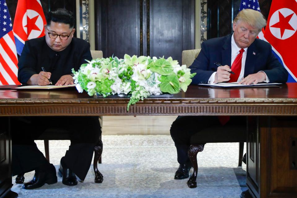  North Korea leader Kim Jong-un and US President Donald Trump sign documents at their summit