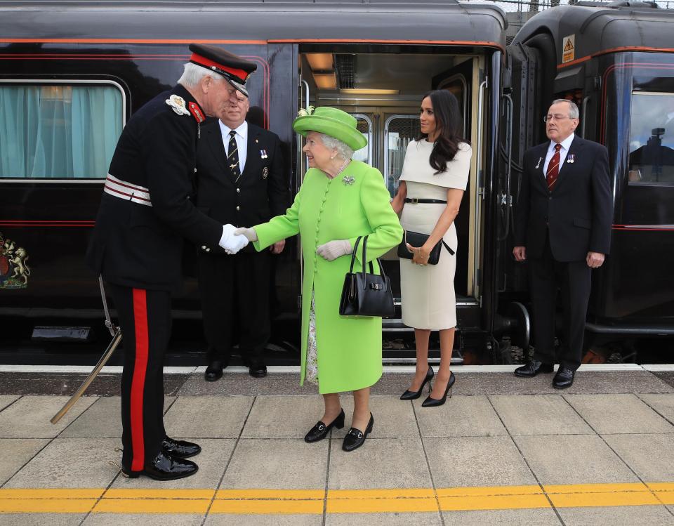  Meghan stood demurely by The Queen's side as they greeted local dignitaries