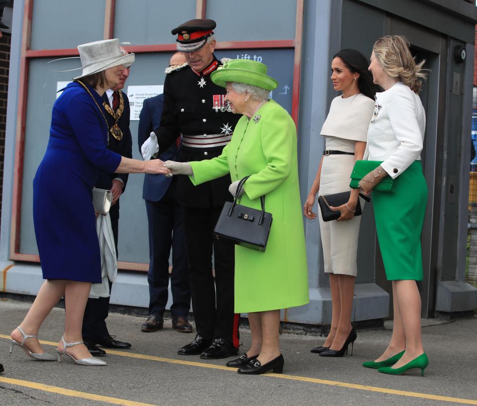  The Queen made sure that Meghan wouldn't outshine her - wearing a bright green outfit for the day