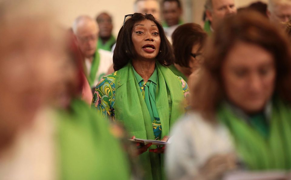  A woman sings during the memorial service at St Helen's Church on Thursday morning