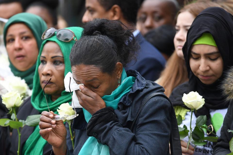  A woman dries her eyes during the emotional anniversary of the disaster