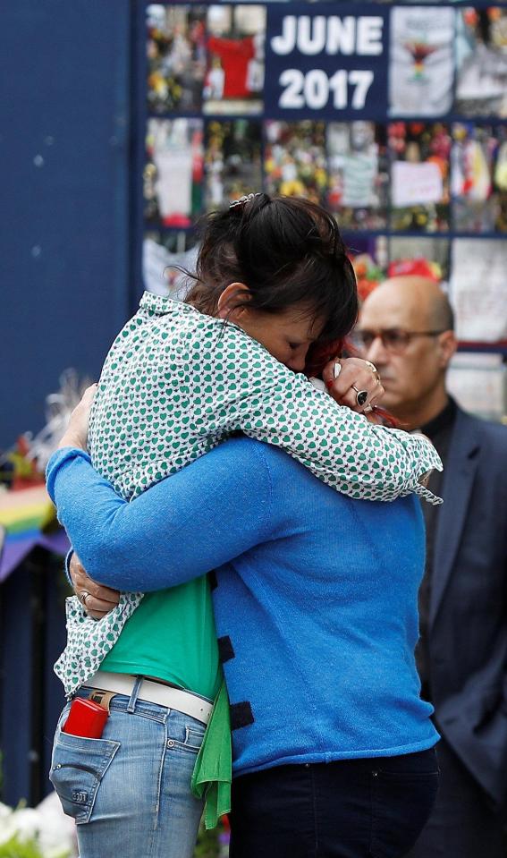  Two friends embrace as the country fell silent to remember the victims of the Grenfell Tower fire