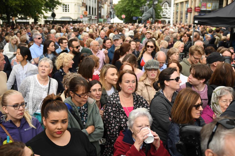  Well-wishers wait for the arrival of Britain's Queen Elizabeth II and Meghan, Duchess of Sussex at the Storyhouse