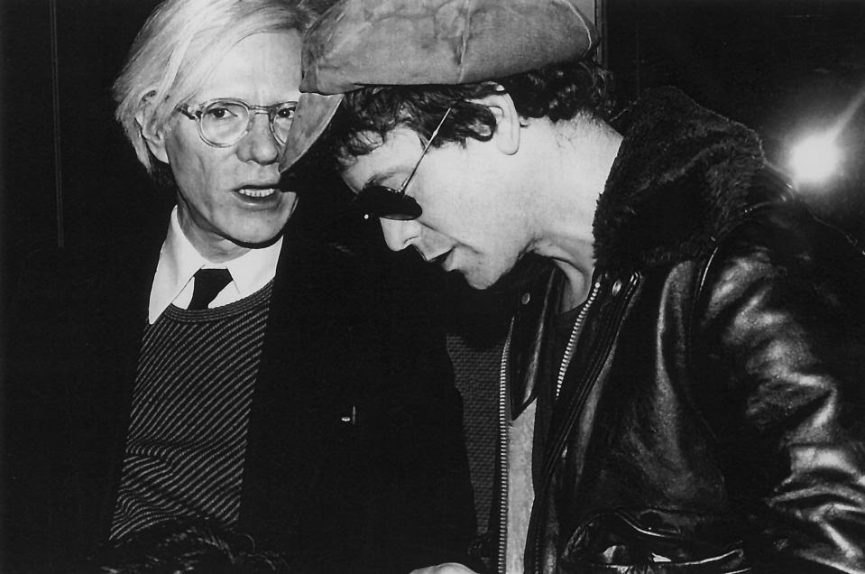  Pop artist Andy Warhol and singer and musician Lou Reed chat at Studio 54 in 1977