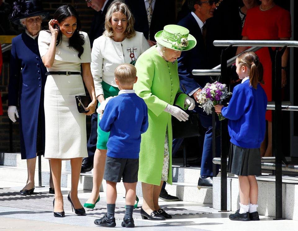  Meghan and the Queen were handed flowers to thank them for their visit