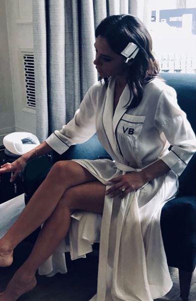  Victoria Beckham flashed her legs in a silky robe as she got ready for a fashion shoot