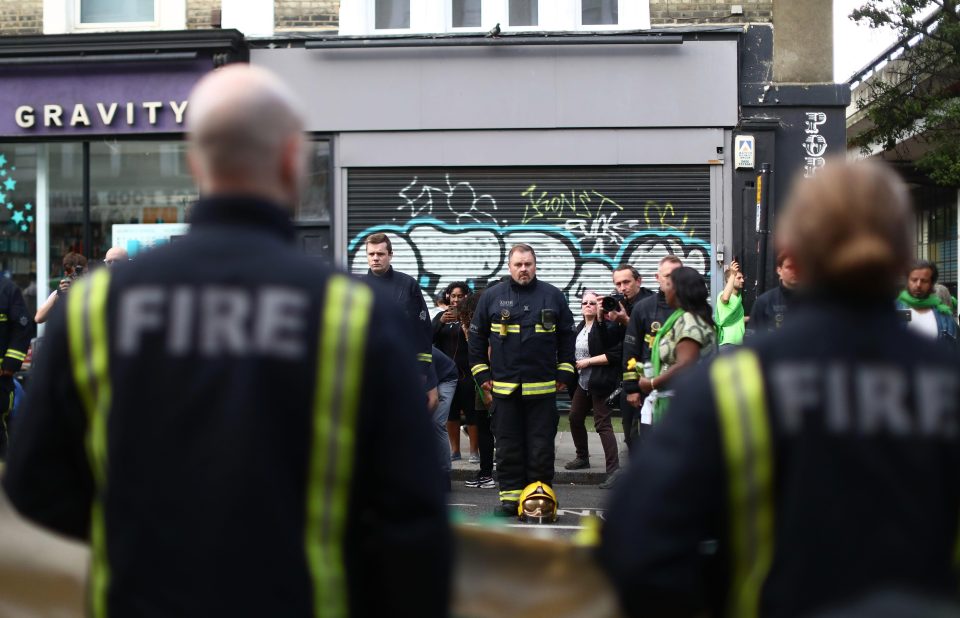  Firefighters line the street during the silent march