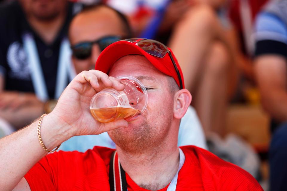  An England fan enjoys a pint in Volgograd's Fan Zone