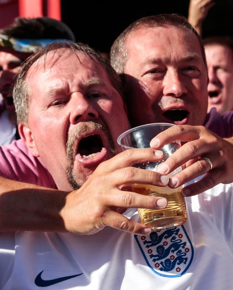  England fans enjoy a pint after England's win in their opening game