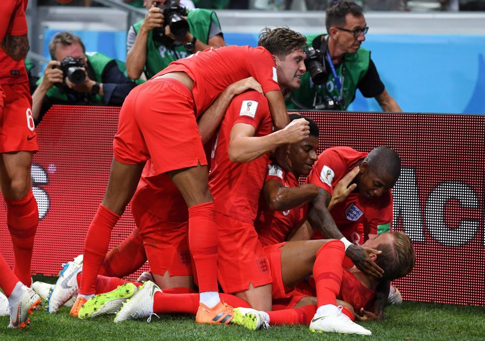  England players mob Harry Kane following his second goal in Volgograd