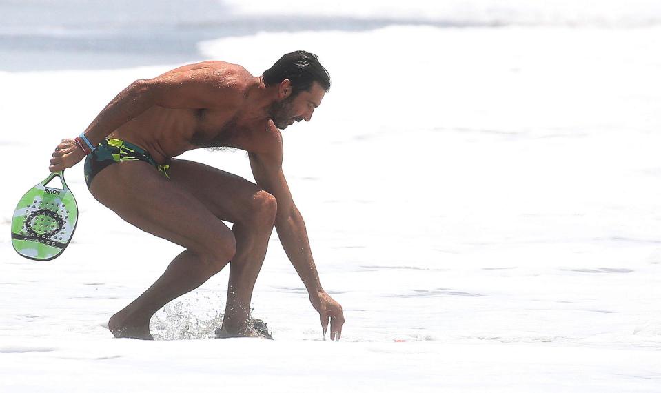  Italy stopper Gianluigi Buffon swapped football for bat and ball on the beach