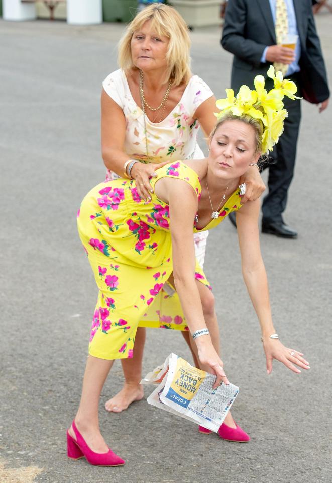  Two racegoers put on a show for photographers at Royal Ascot today