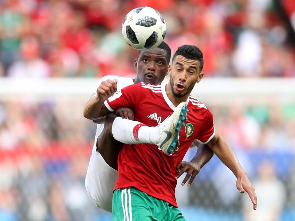  William Carvalho gets a foot to the ball ahead of Morocco's Younes Belhanda