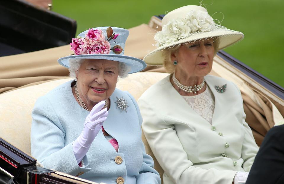  The Queen waves from her horse-drawn carriage as she arrives for the second day of Ascot