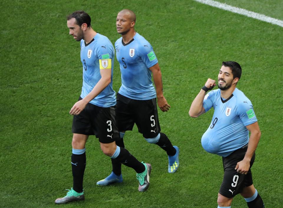 Luis Suarez celebrates his goal in his 100th international game