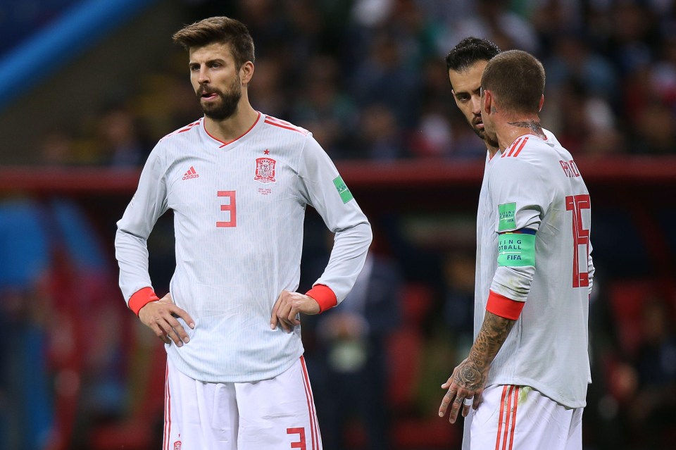 Gerard Pique, midfielder Sergio Busquets and defender Sergio Ramos look frustrated during the first half