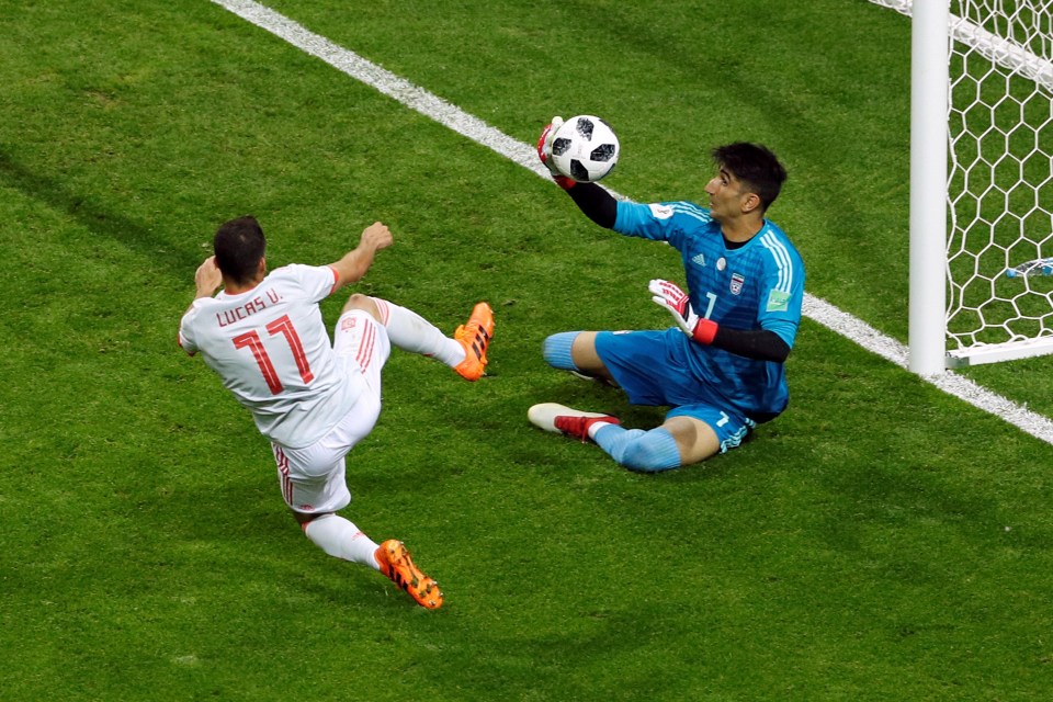 Alireza Beiranvand gets to the ball just before Spain forward Lucas Vazquez